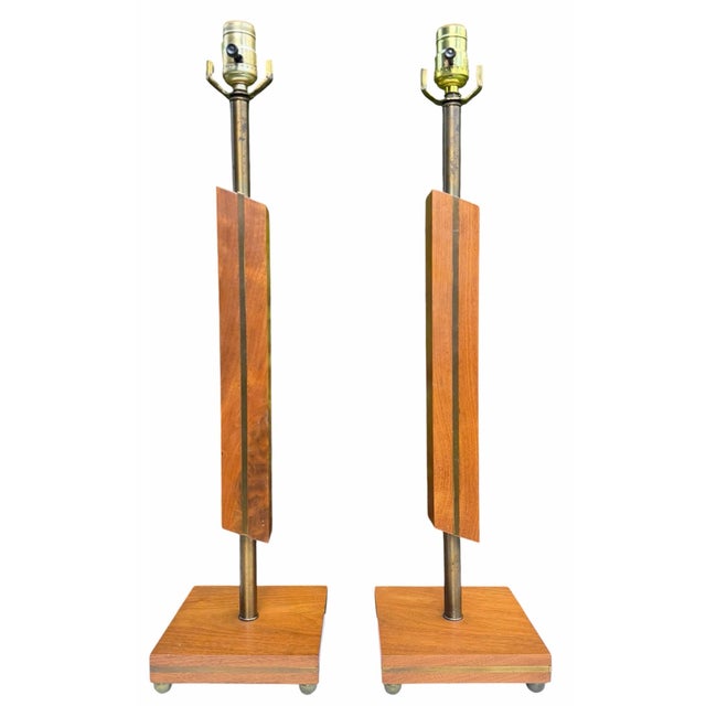 Striking pair of Mid-Century Modern architectural table lamps crafted with sculptural geometric forms, warm walnut, and...