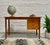 Beautifully crafted in Denmark, this Mid-Century Modern teak desk is as functional as it is striking. The double-sided...