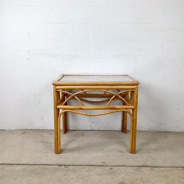This beautifully crafted vintage rattan side table is a testament to the high artisanship that defined the best American...