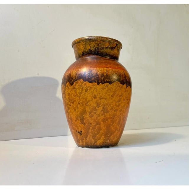 Unusual vase hand-painted in orange, yellow and brown nuances. Designed and manufactured by Knabstrup in Denmark during...