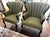 A striking pair of vintage wingback chairs in sage green upholstery with elegantly carved cabriole legs. The graceful...