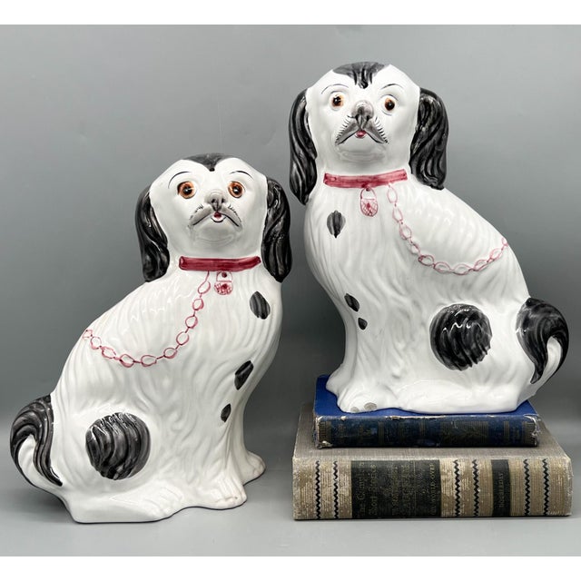 Gorgeous Staffordshire style dogs in the form of black and white spaniels with sweet hand painted faces and pink collars...