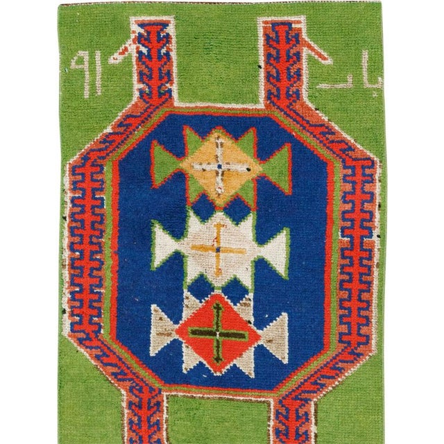 This mid-20th-century Turkish Anatolian runner features three large, vertically aligned medallions set against a vivid...