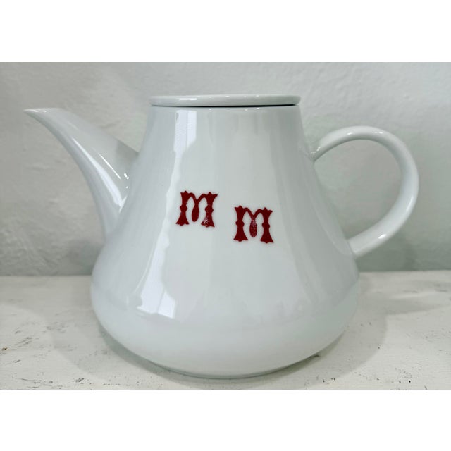 Vintage Midcentury era white porcelain teapot and burgundy letters M M monogram. Marked on underside Khala.