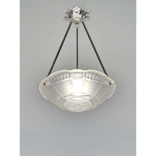 Marius Sabino A French 1930 art deco pendant light in nickel plated solid brass or bronze holding a signed bowl by Sabino....