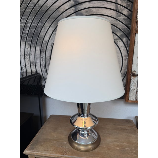 Design Plus Gallery presents a Modernist Table Lamp with Chrome + Brass Base. The table lamp has a unique shape of shiny...