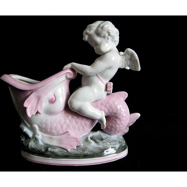 I love this absolutely adorable porcelain cupid riding a “classical” dolphin on waves. So French! It has a delicate...