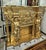 Create a dramatic focal point with this grand French-style fireplace mantel, richly decorated with an elaborate gold leaf...
