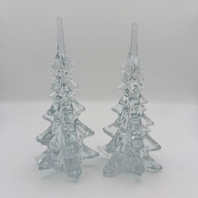 A striking pair of vintage clear glass Christmas trees, their elongated silhouettes built from sculptural tiers of...