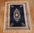 An early 20th century fine Turkish Ghiordes rug featuring an elegant floral motif with a navy ground, accents in peach,...