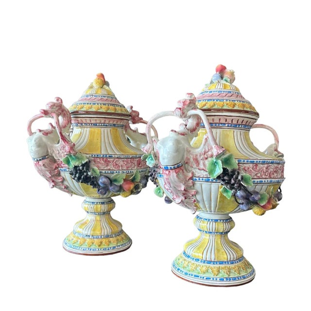 Pair of large antique Italian Yellow & White Majorca Urns Tureens adorned with intricate fruit motifs stands as timeless...