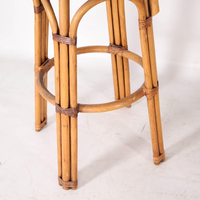 Beautiful set of four bar stools in woven rush and rattan, circa 1970. Comfortable with their small floral cushions, wide...