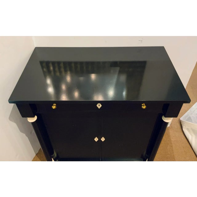 Stylish Theodore Alexander Modern Ebony Finished William Bar, columns with ivory finished wood detail, brass finished...