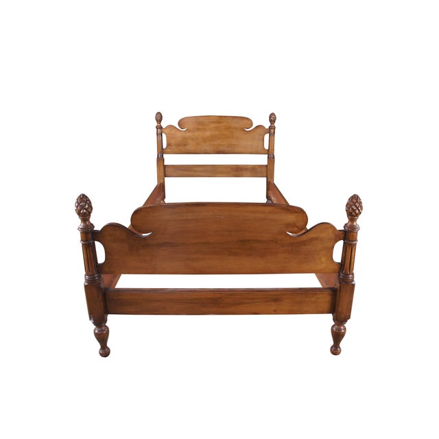 Mid Century full size Colonial style bed featuring a walnut finish with carved pineapple posts and serpentine / fluted...