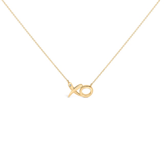 Whispering a promise in precious metal, this embrace-and-kiss necklace traces a smooth, rounded script in sunlit yellow,...