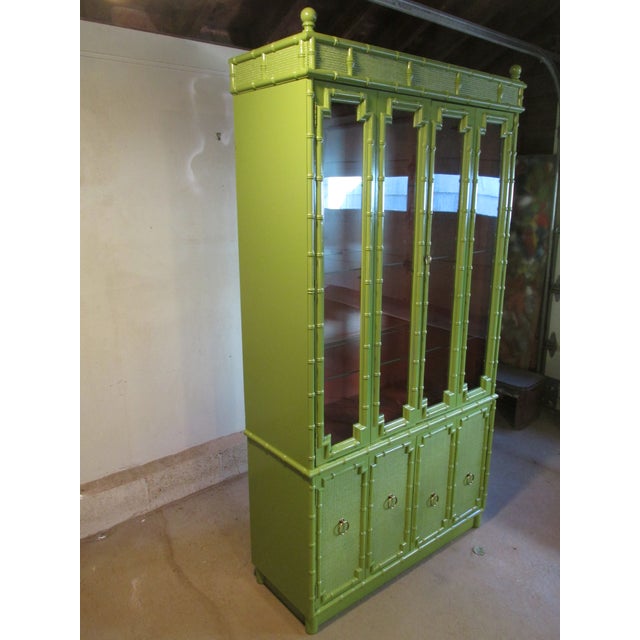 Vintage Chinoiserie Style china cabinet by Drexel for its Kensington line, circa 1960s. Painted faux bamboo and faux...