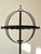 Large sculptural “Light Globe” candle holder in solid cast iron, inspired by medieval ecclesiastical forms and...