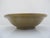 Antique green-glazed ceramic vessel resembling historic Yue-ware or early celadon bowl styles, featuring an olive-toned...