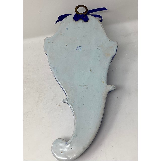 Delft wall pocket initialed on back MP. Decorated with a couple standing near water with birds overhead and surrounded by...
