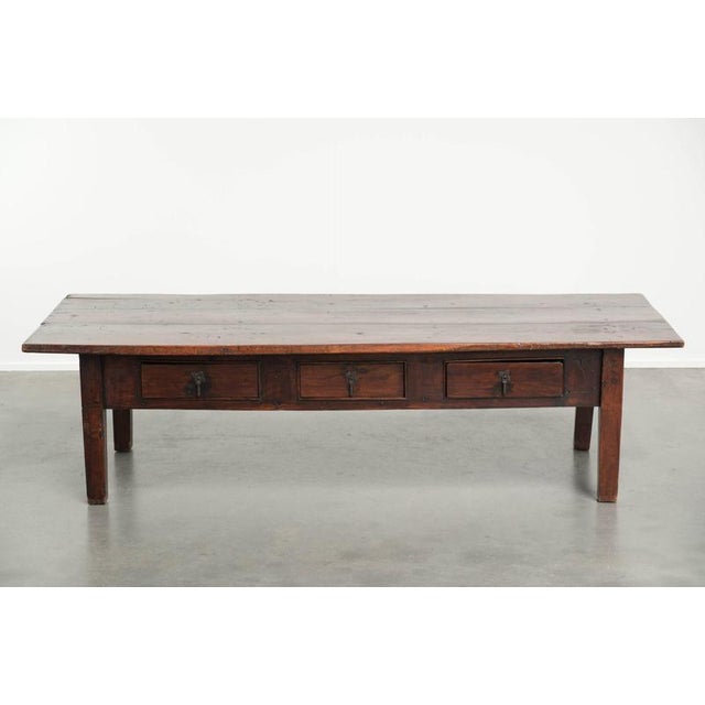 This very beautiful antique Southern European coffee table features 3 drawers, beautiful warm colors, and a timeless,...