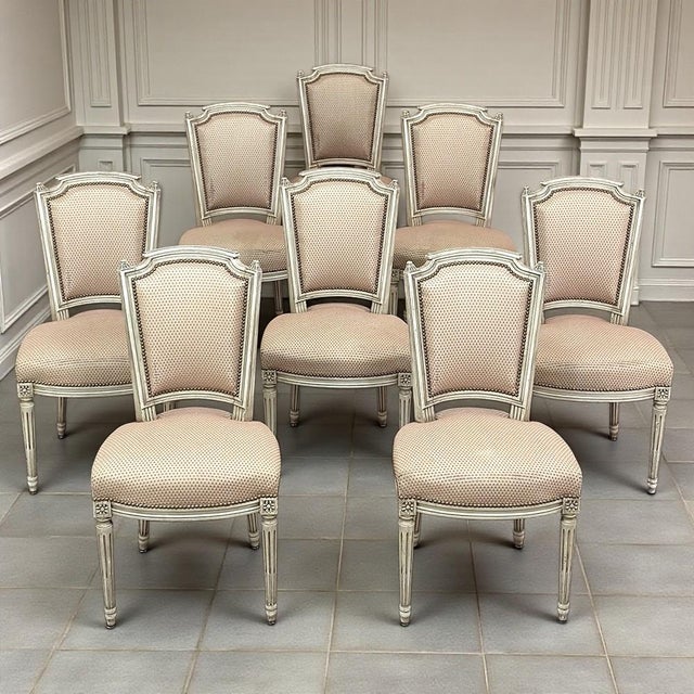 Set of 8 French Louis XVI painted dining chairs, designed with the restrained symmetry and graceful architecture that made...