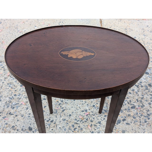 This Mahogany Federal Style Shell Inlay Occasional Table is a refined tribute to early American neoclassicism, blending...