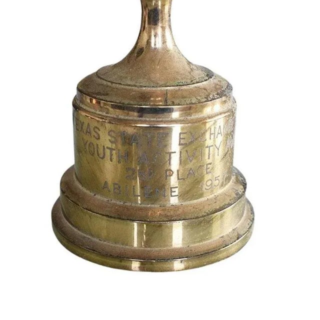 A tall brass metal trophy from the Texas State Exchange Clubs. This Trophy features a figural woman with wings atop a...
