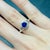 A sapphire sits in a rich blue at the centre of this solid 14K white gold ring, encircled by ten earth-mined diamonds....