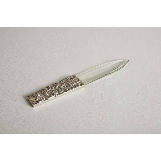 rare letter opener with thick ground glass blade and embossed silver handle with sironian motifs. Production arrigo finzi...