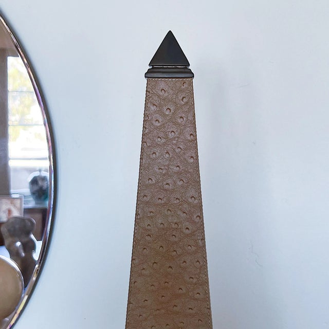 Mid-Century Hollywood Regency Obelisk in Brass and Tan Leather Measures approx 18H x 5 x 5 Please visit my other listings...