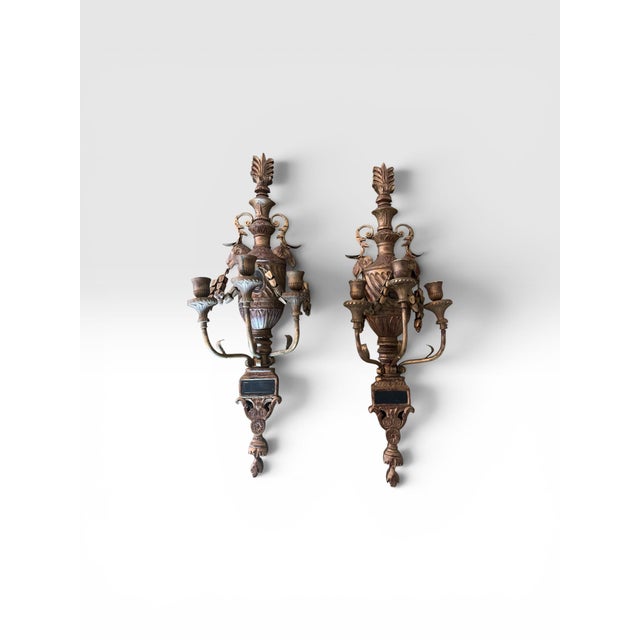 Impressive pair of monumental vintage Rococo Revival wall sconces, beautifully crafted with carved wood bodies and...