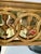 A sophisticated vintage neoclassical mirror featuring an architectural frieze of interlocking rings and classical arrow...