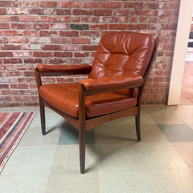 Vintage mid-century modern Carmen lounge chair in stained beech and cognac leather designed by Gunnar Kentemo for Göte...