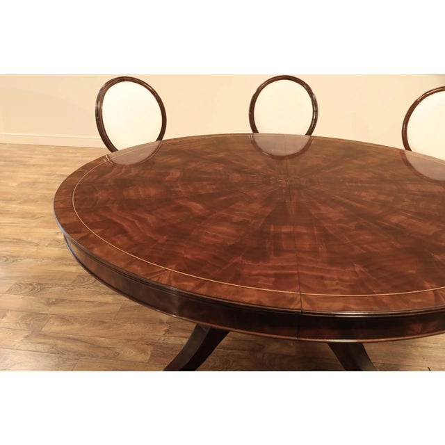 72"-100" Round to oval mahogany dining room table. This pedestal table has a 28" self-storing butterfly leaf and it stands...
