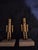 This is a pair of vintage decorative metal nutcracker figurines mounted on heavy rectangular stone or marble bases,...