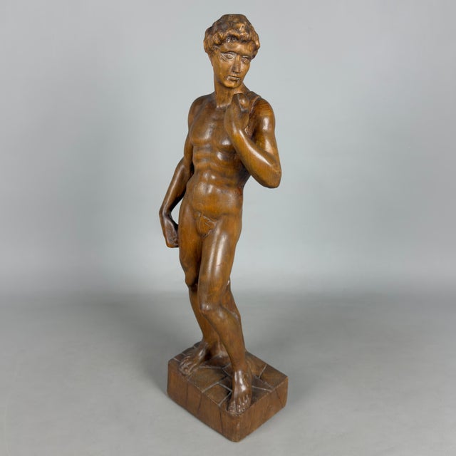 A striking and slender tabletop sculpture in the round depicting Michelangelo's famous David, a fine example of Italian...