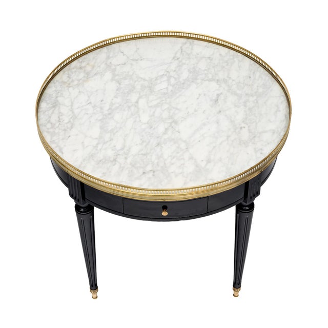 Side table from France in the Louis XVI style. This charming side table is made of solid wood construction, primarily...