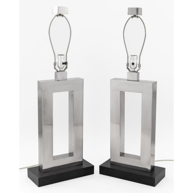 Pair of Robert Abbey "Doughnut" Style Chrome Table Lamps, with rectangular bodies, square finials, and atop ebonized...