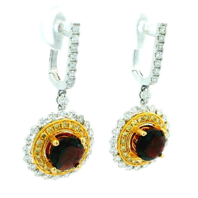 Elegant and beautifully detailed, these Italian drop earrings feature rich wine-red round garnets framed by two sparkling...