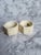 Set of 2 vintage celluloid napkin rings. Both are faceted and have raised floral and leaf design. The original sticker is...