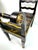A striking Chinoiserie-style accent bench featuring a black lacquered finish with finely hand-painted gilt decoration...