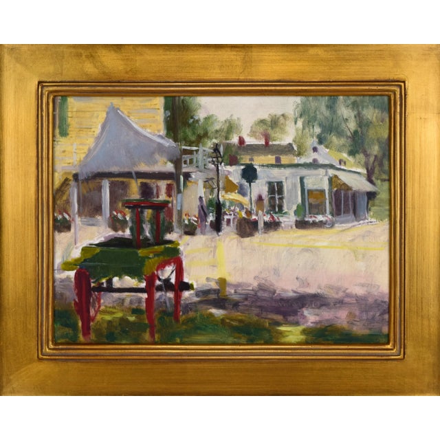 Vintage American Impressionist landscape painting of a scene in a quiet downtown with a vendors cart in the foreground by...