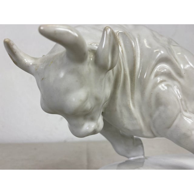 This is a pottery blanc de chin Sculpture of a bull. this dynamic sculpture of a bull is in a cream color glaze and the...