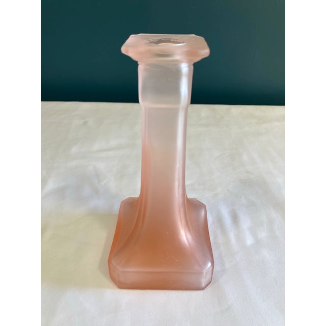 A sculptural frosted glass taper candleholder by Taitu, Italy, featuring a soft blush satin finish and architectural...