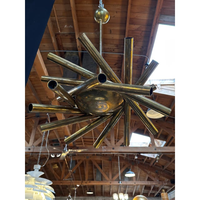 The Mid Century Italian Small Stilnovo Orbit Chandelier, crafted in brass and originating from Italy in 1955, is a compact...