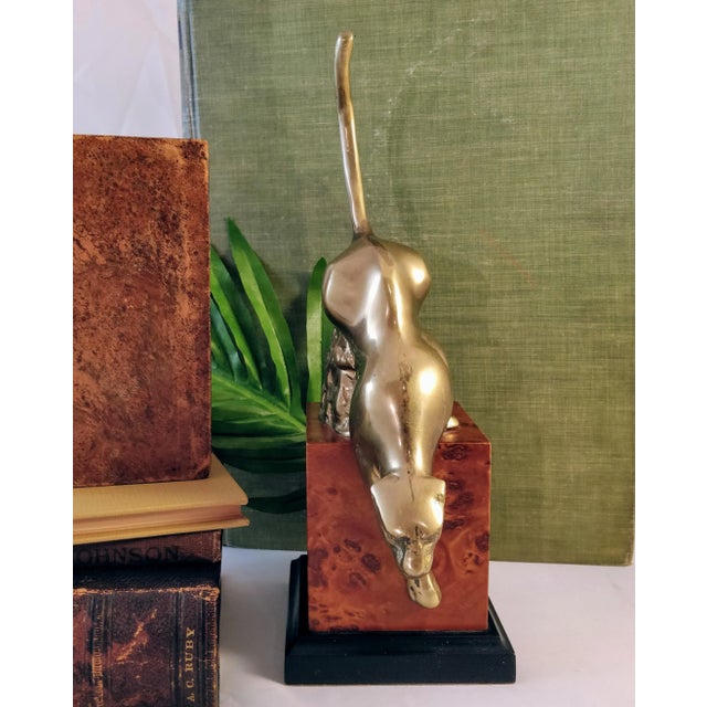 Stunning brass mountain lion on a wood square base. The details are exquisite and so well done. The cat has a lovely brass...