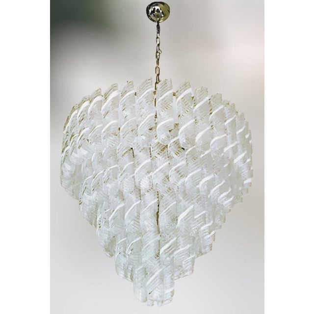 Italian chandelier with clear and white stripe Murano glasses hand blown to produce elegant swirls, mounted on chrome...