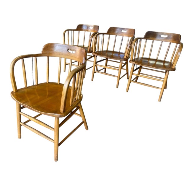 A set of four mid century arm chairs Classic Americana Spindle Back and legs Wood appears to be oak or maple Possibly...