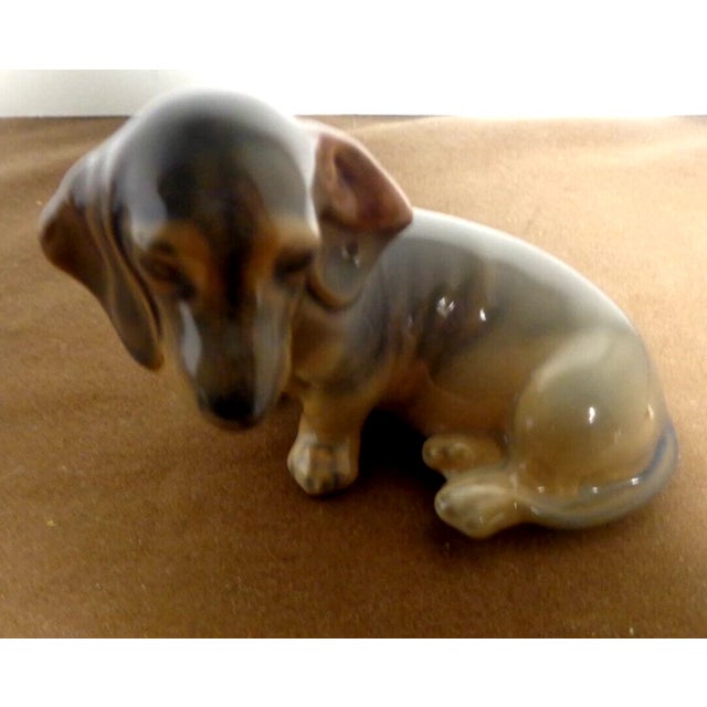 Celebrate the charm of man's best friend with this Vintage Royal Copenhagen Dachshund Puppy Figurine. Expertly handcrafted...