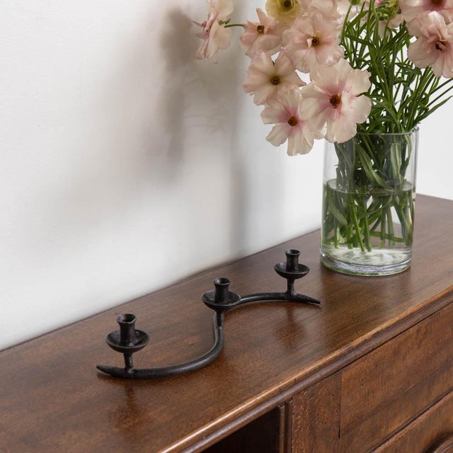 Lovely petite wavy iron candlestick from France, 1950s. Beautiful thin curved iron frame with three petite heads to hold...